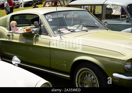 The front of a green 1968 Ford Mustang on display at a car show Stock Photo