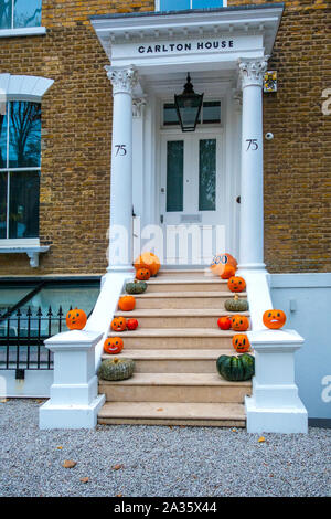 Halloween pumpkin decorations on the steps of a London house Stock Photo