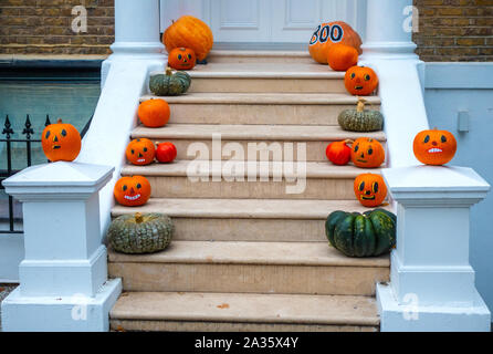 Halloween pumpkin decorations on the steps of a London house Stock Photo