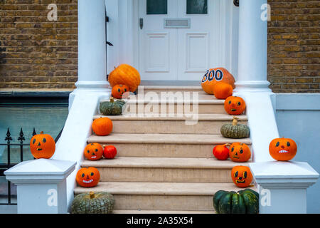 Halloween pumpkin decorations on the steps of a London house Stock Photo