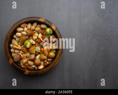 Assorted nuts and pumpkin seeds in wooden bowl, vitamin E rich food, vegan food, snack Stock Photo