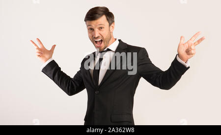 Excited Man Shouting Spreading Hands Standing On White Background Stock Photo