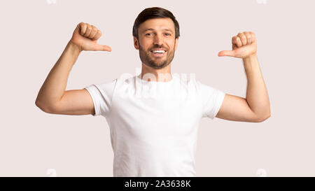 Man Pointing Thumbs At Himself On White Background, Panorama Stock Photo