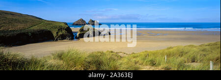 A panoramic image of the popular Holywell Bay beach in North Cornwall UK. The rocks just offshore are known as Carter's Rocks or Gull Rocks Stock Photo