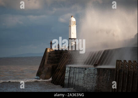 Porthcawl, County Borough of Bridgend, Wales, UK. 29th September 2019. Anglers brave the crashing waves at Porthcawl Lighthouse in south Wales. Stock Photo