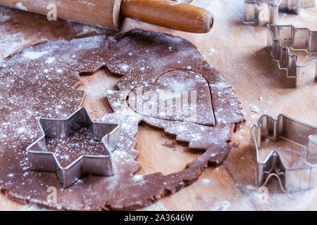 Raw christmas homemade gingerbread dough rolled out with Christmas shapes Stock Photo