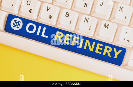 Handwriting text Oil Refinery. Conceptual photo industrial process of converting crude oil into petroleum White pc keyboard with empty note paper abov Stock Photo