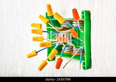 Installation electric distribution box  with wiring cap connectors twist-on type. Mounting electrical junction box made of plastic with screw-on wire Stock Photo