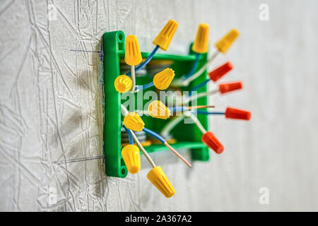 Splice electrical wires using wire connectors. Electric wire connectors are twist-on or wire nuts. End caps for electrical wires are wire caps or wire Stock Photo