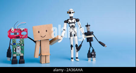 Four different handmade robots on blue background Stock Photo