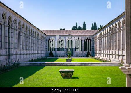 View from gallery on internal garden, Camposanto Monumentale di Pisa. Monumental Cemetery courtyard. Ornate columns and arches. Pisa, Italy, Tuscany Stock Photo