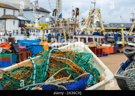 fishing nets with fishing trawlers in the background Stock Photo