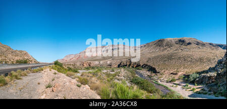 Panoramic View Showing Two Way Road and Small River Flowing In the Mountains Stock Photo