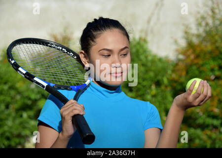 Cute Fit Asian Female Tennis Player With Tennis Racket Stock Photo