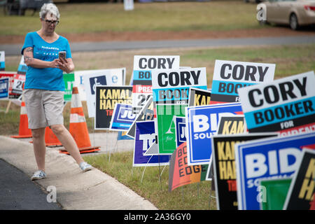 Charleston, United States. 05 October, 2019. A woman stops to take a photo of the sea of campaign signs at the annual SCDP Blue Jamboree October 5, 2019 in Charleston, South Carolina. Credit: Richard Ellis/Richard Ellis/Alamy Live News Stock Photo