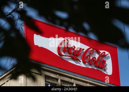 Bucharest, Romania -  September 29, 2019: A very large logo of Coca-Cola soft drink manufacturer is displayed on the top of a block of flats, in Bucha Stock Photo