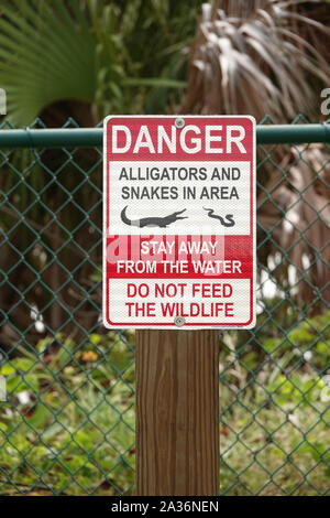Sign 'Alligators and snakes in the area' in Florida, USA Stock Photo