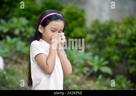 A Pretty Girl Child In Prayer Stock Photo