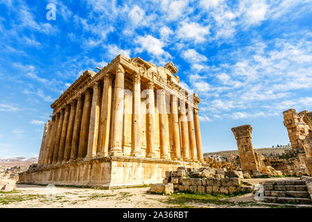 Ancient Roman temple of Bacchus with surrounding ruins with blue sky in the background, Bekaa Valley, Baalbek, Lebanon Stock Photo