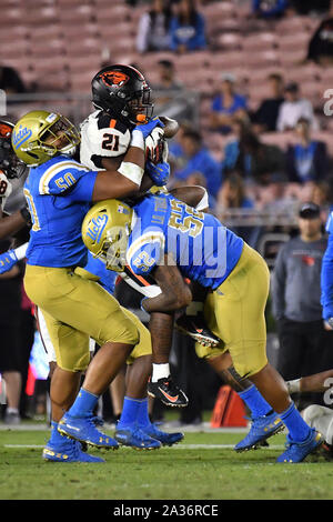 Pasadena, CA. 5th Oct, 2019. Oregon State Beavers running back Artavis Pierce (21) runs and is tackled by UCLA Bruins defensive lineman Tyler Manoa (50) and UCLA Bruins linebacker Lokeni Toailoa (52)in action during the second half of the NCAA Football game between the UCLA Bruins and the Oregon State Beavers at the Rose Bowl in Pasadena, California.The Oregon State Beavers defeat the UCLA Bruins 48-31.Louis Lopez/CSM/Alamy Live News Stock Photo