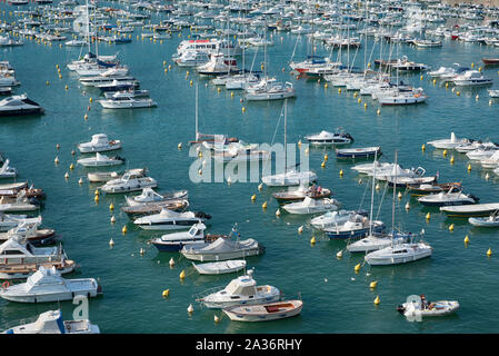 High angle view of boats and yachts aligned while floating on the sea water moored in a marina during a sunny day of summer Stock Photo