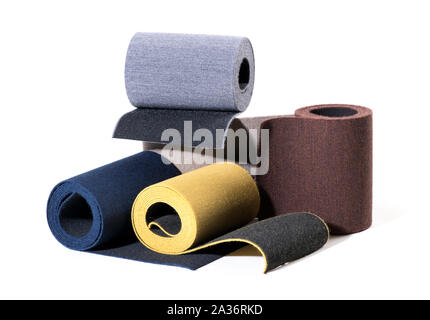 Selection of textured colored elastic ribbon on rolls displayed together over white for use in the manufacturing industry for fashion and footwear Stock Photo