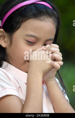 An A Filipina Girl Praying Stock Photo