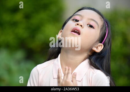 Young Filipina Girl With Sore Throat Stock Photo
