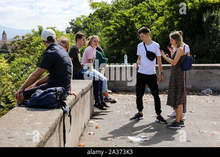 Young tourists on Terrazza Piazza Garibaldi viewpoint in Trastevere district of Rome, Italy Stock Photo
