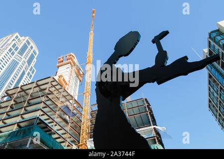 Seattle, Washington, USA. The high rise building is in the midst of construction behind the Hammering Man sculpture by Jonathan Borofsky. Stock Photo