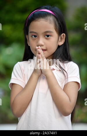 A Young Diverse Juvenile Praying Stock Photo