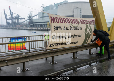 GERMANY, Hamburg , activists of deCOALonize europe block the Kattwyk bridge near Vattenfall coal power station Moorburg to protest against coal burning and hard coal imports, banner says: Moorburg switch-off, 80 percent of electricity used in Hamburg comes from burning of hard coal Stock Photo