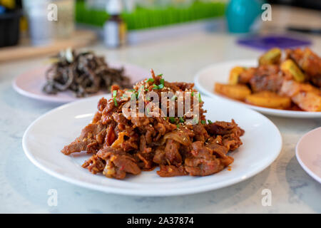 Fried pork(Bulgogi) with spicy korean sauce on a plate Stock Photo