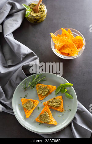 Nachos chips or corn mexican chips with pesto pasta healthy food snack isolated closeup
