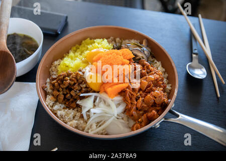 Albap- Korean rice with Tobiko egg, is orange (flying fish roe) on Frying Pan Stock Photo