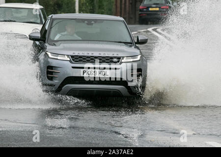 Blackpool, Lancashire, UK. 6th October 2019.   After a night of torrential rain downpours, local residents awoke to find roads virtually impassable as rain waters flood the highways of Blackpool in Lancashire.  Precarious driving conditions as the flood waters caused localised travel chaos and disruption with some arterial routes closed completely.  Credit: Cernan Elias/Alamy Live News Stock Photo