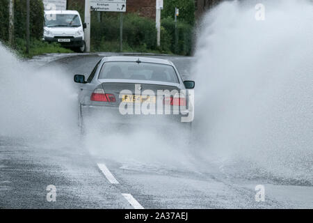 Blackpool, Lancashire, UK. 6th October 2019.   After a night of torrential rain downpours, local residents awoke to find roads virtually impassable as rain waters flood the highways of Blackpool in Lancashire.  Precarious driving conditions as the flood waters caused localised travel chaos and disruption with some arterial routes closed completely.  Credit: Cernan Elias/Alamy Live News Stock Photo