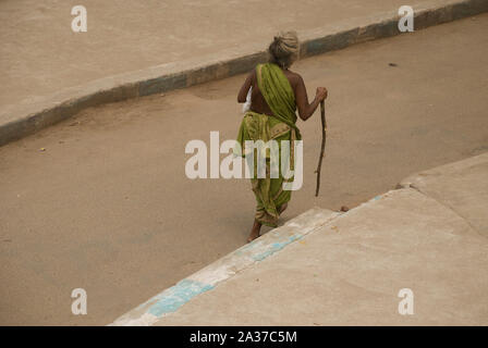 Madurai, Tamil Nadu, India - October 22, 2010: Homeless woman walking in the streets of Madurai. There are an estimated 1.8 million homeless people in Stock Photo