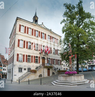 Delemont, Jura / Switzerland - 28 August, 2019: view of the historic 'Fontaine de la Vierge' or Fountain of the holy Virgin and the city hall building Stock Photo