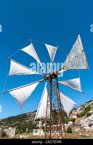 Lasithi Plateau, Eastern Crete, Greece.  Windmill pumping water for irrigation in this scenic location surrounded by the Dikti mountains. Stock Photo