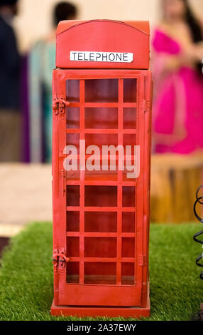 A Small old telephone exchange Prop for decoration in red color. this is a Old Public telephone booth for connecting each other in 19th century Stock Photo