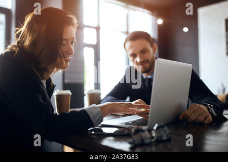 positive man and woman having a successful meeting, creative designers talking at lunch time. close up photo Stock Photo