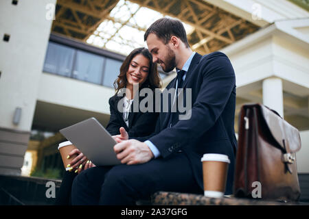 two office people having fun in the street, close up side view .leisure concept Stock Photo