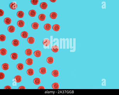 Red plastic buttons on blue background Stock Photo