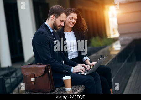 smiling young businesswoman and businessman making up a new idea to achieve aim, close up photo Stock Photo