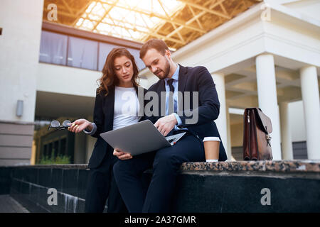 young co-workers discussing a new contract, brainstorming in the street. close up photo Stock Photo