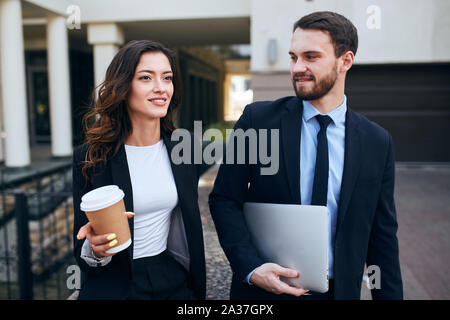 two good looking office workers leaving working place, close up photo. leisure concept Stock Photo