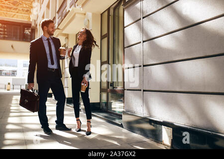 positive young office workers having fun in the street, friendshipo, happiness, full length photo. copy space Stock Photo