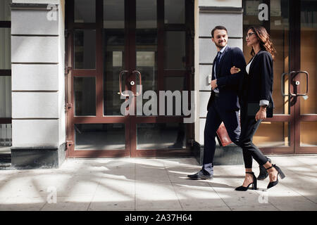 family business, young couple starts business, full length side view photo.man and woman rushing to the aim Stock Photo