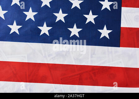 Close up of american flag over usd dollar bills background. Financial concept Stock Photo